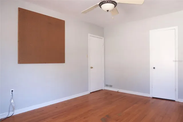 an empty room with wooden floor