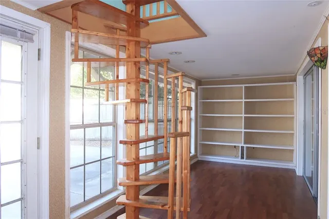 a view of a room with wooden floor and windows