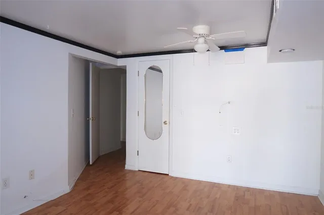 an empty room with wooden floor and mirror