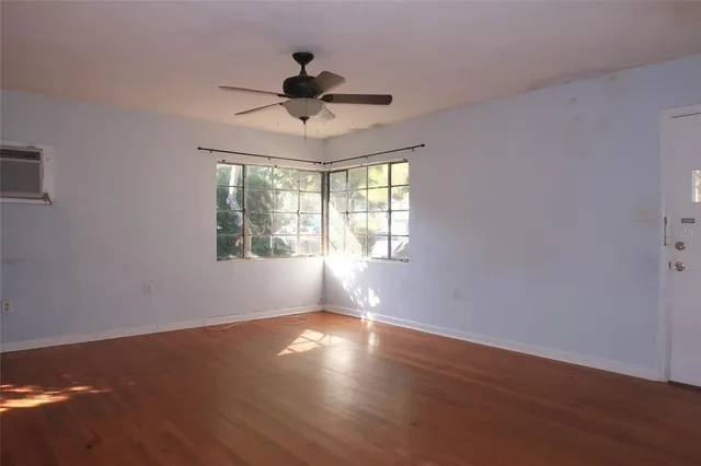 a view of wooden floor and windows in a room