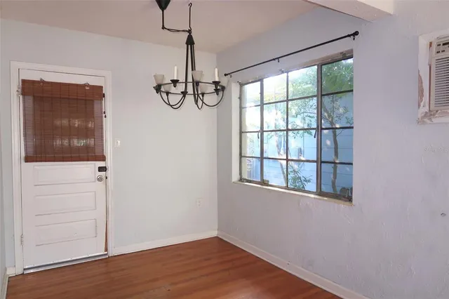 a view of empty room with windows and wooden floor