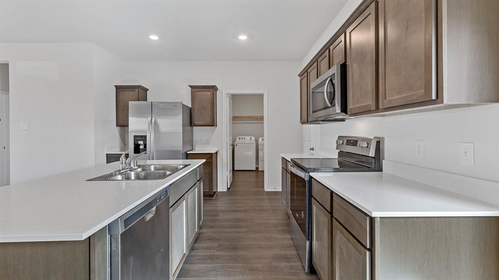 212 Pheasant Run Road Terrell, TX 75160 - Photo 11 of 24 Kitchen featuring wood-finish flooring, recessed lighting, and stainless steel appliances