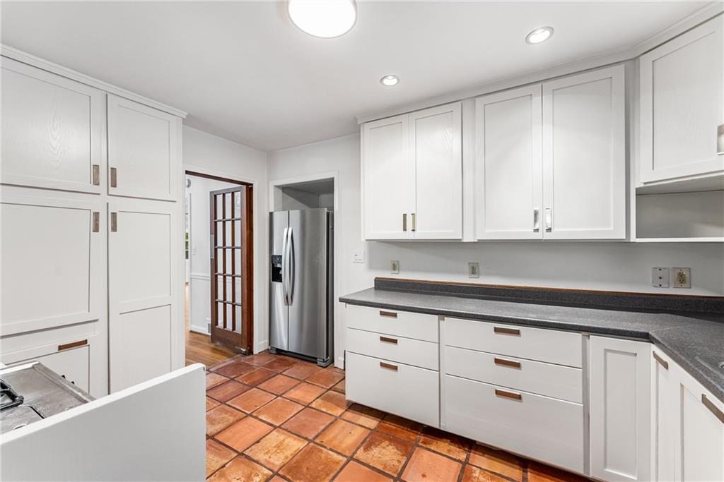 1469 Clairmont Road Decatur, GA 30033 - Photo 11 of 24 a kitchen with granite countertop white cabinets and white appliances