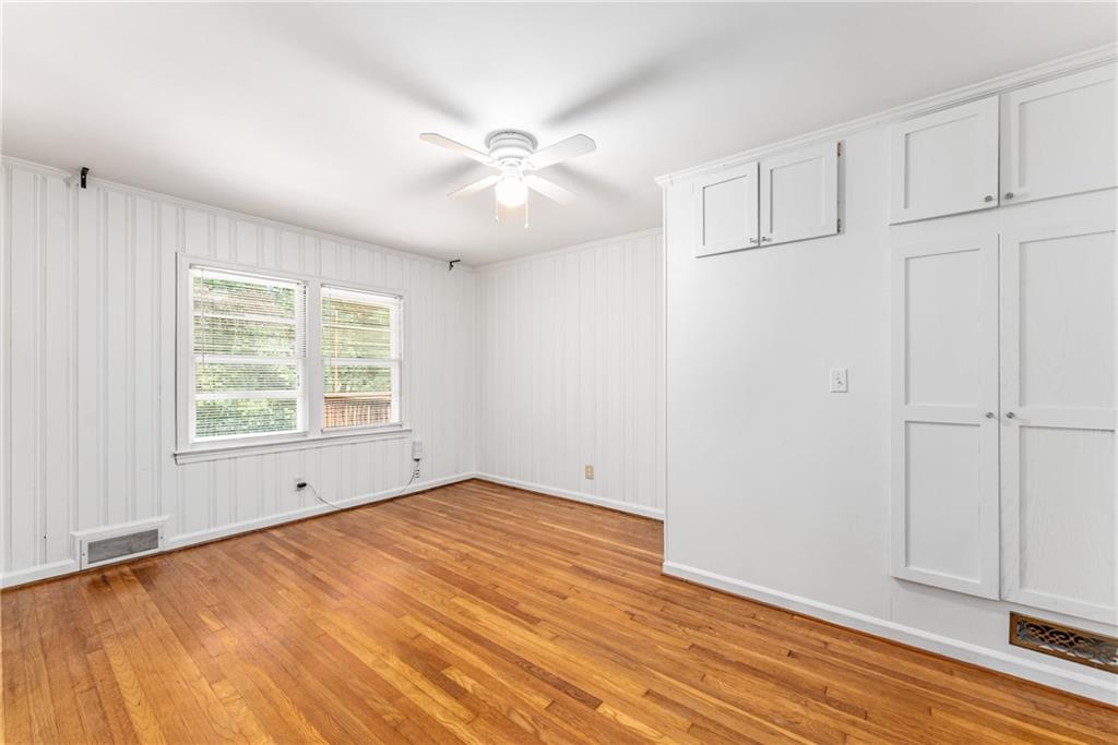 1469 Clairmont Road Decatur, GA 30033 - Photo 19 of 24 a view of an empty room with wooden floor and a window