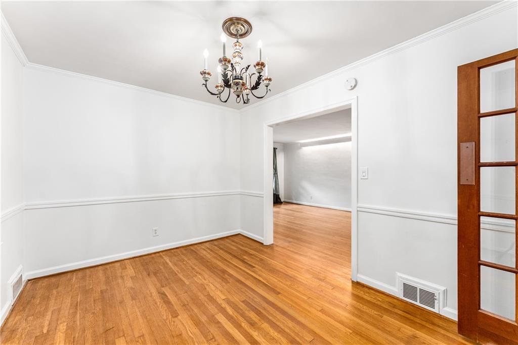 1469 Clairmont Road Decatur, GA 30033 - Photo 7 of 24 a view of a room with wooden floor and a chandelier