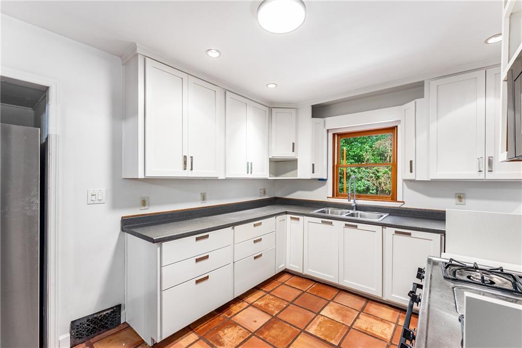 1469 Clairmont Road Decatur, GA 30033 - Photo 9 of 24 a kitchen with a sink window and cabinets