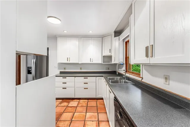 a kitchen with a sink stove and cabinets
