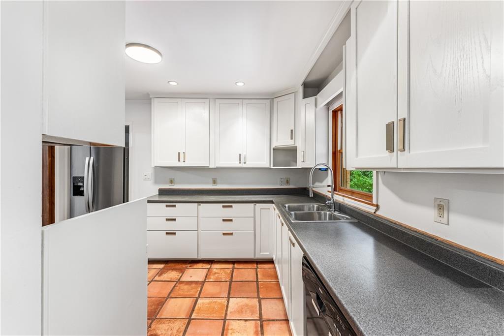 1469 Clairmont Road Decatur, GA 30033 - Photo 10 of 24 a kitchen with a sink stove and cabinets