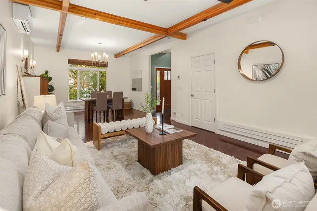 a living room with furniture and a mirror