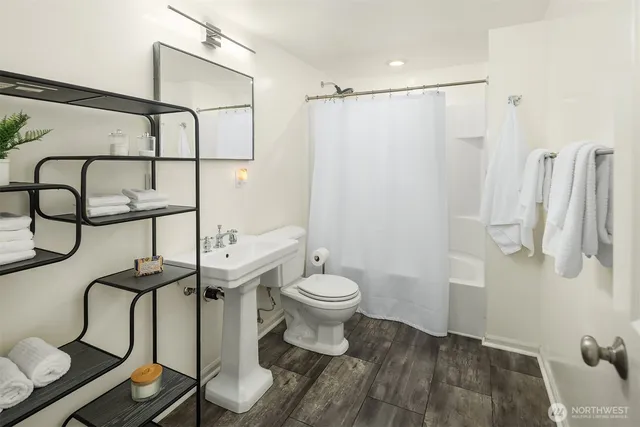 a bathroom with a toilet and a shower
