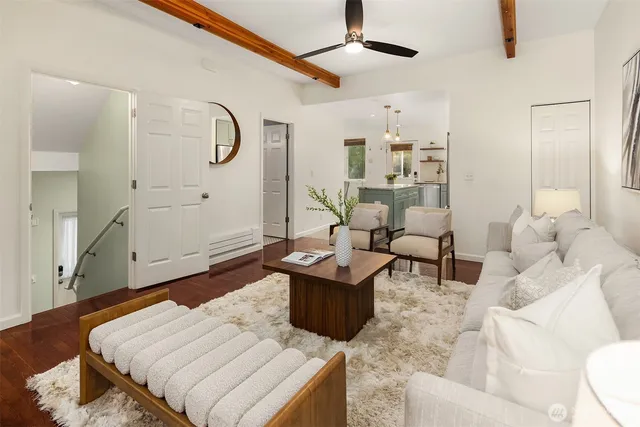 a living room with furniture and wooden floor