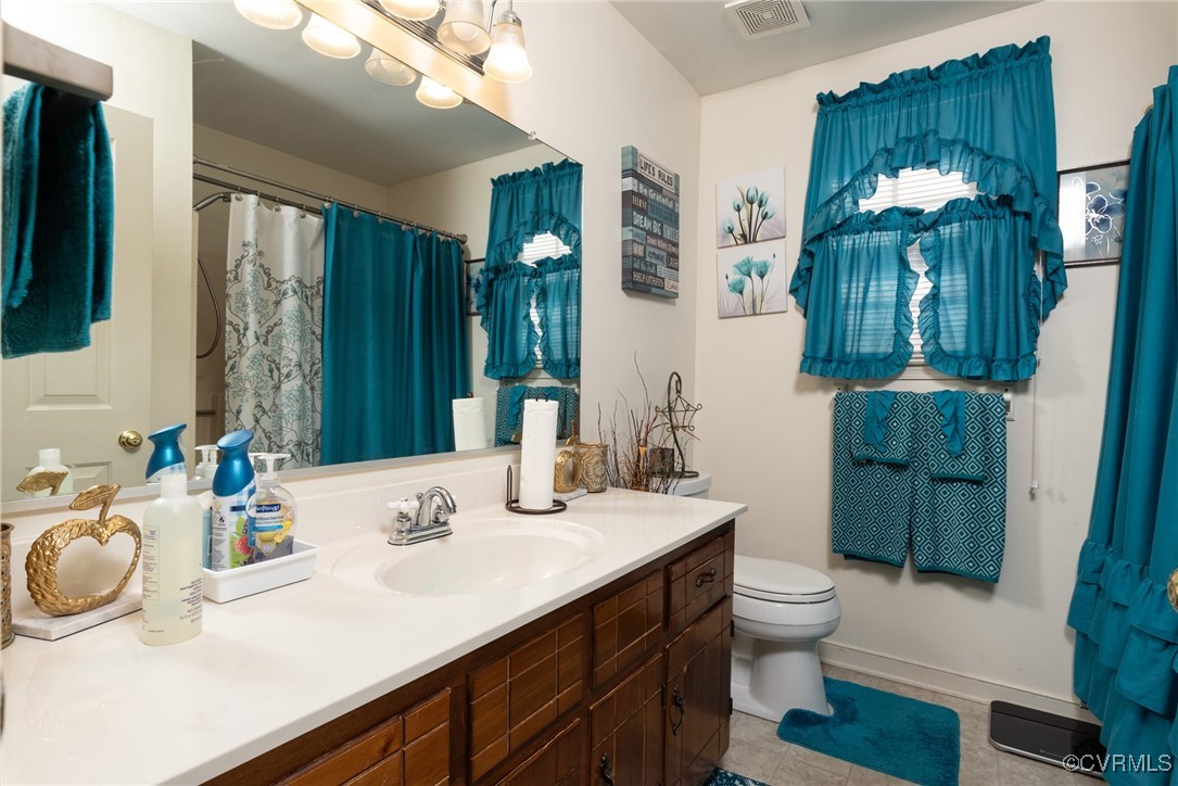 5604 Monguy Road Charles City, VA 23030 - Photo 29 of 49 Hall Bathroom featuring vanity, toilet, baseboards
