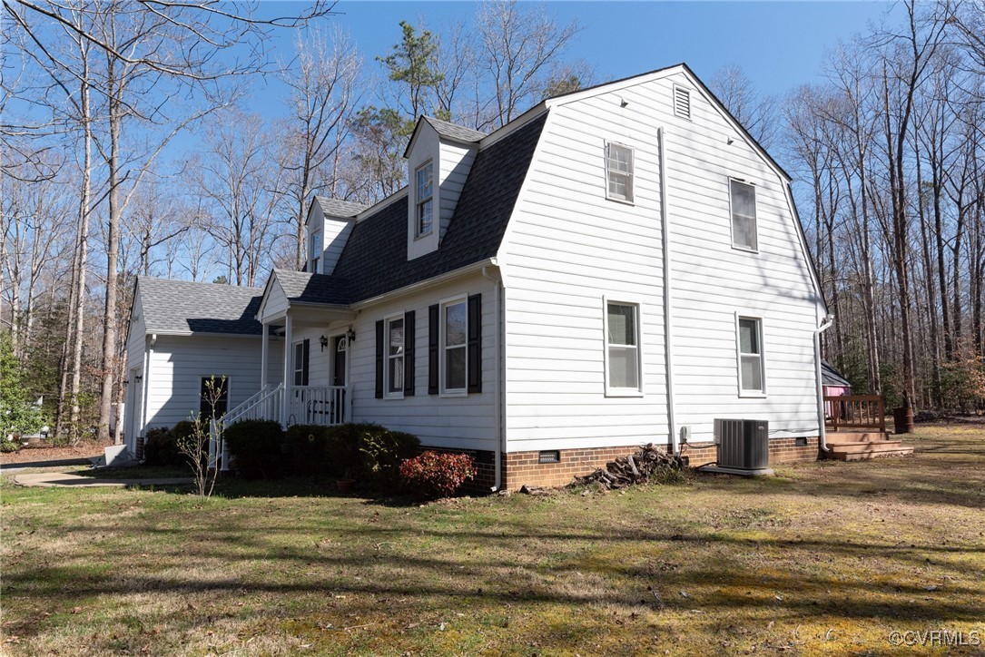 5604 Monguy Road Charles City, VA 23030 - Photo 4 of 49 View of side of property with a lawn, central AC,