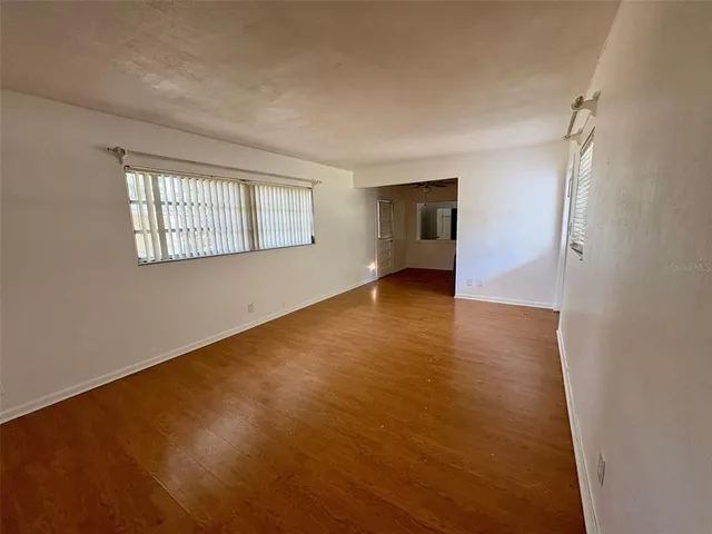an empty room with windows and closet