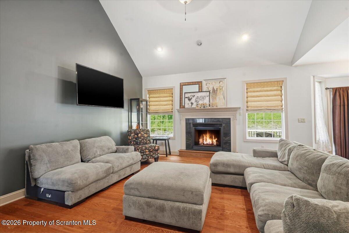 99 Hilltop Road Waverly, PA 18471 - Photo 4 of 41 a living room with furniture a flat screen tv and a fireplace
