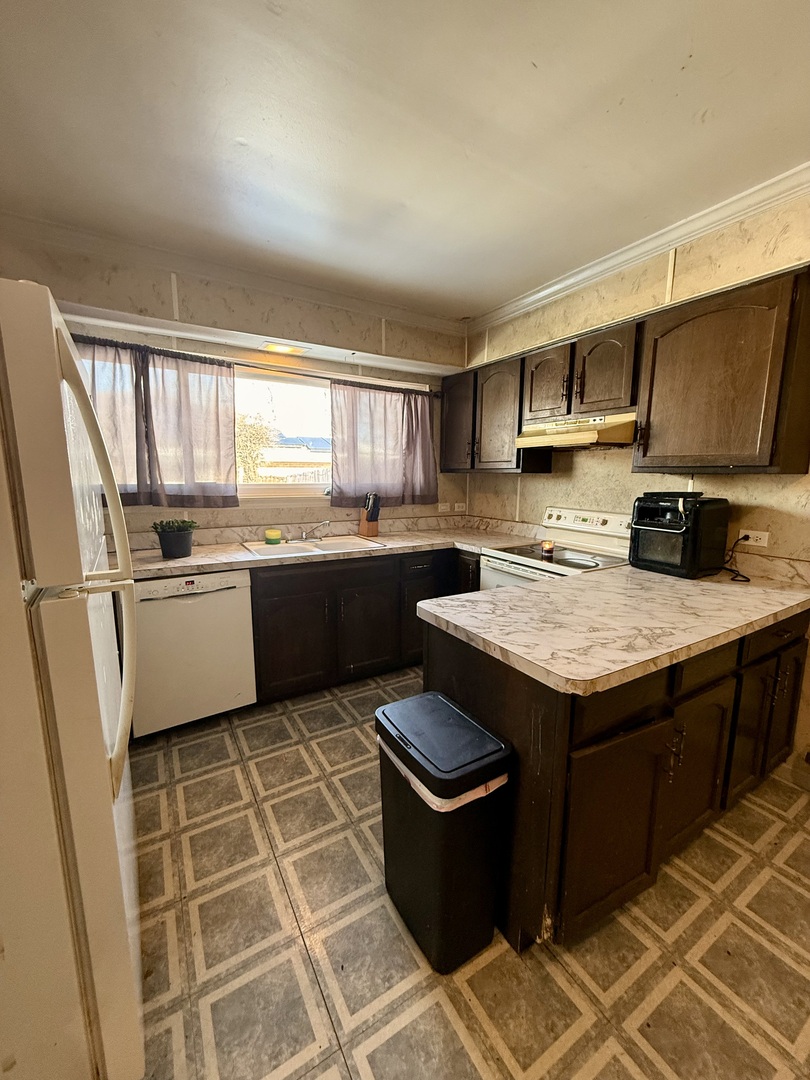 1341 Beverly Lane Streamwood, IL 60107 - Photo 5 of 14 a kitchen with stainless steel appliances granite countertop a sink stove and refrigerator