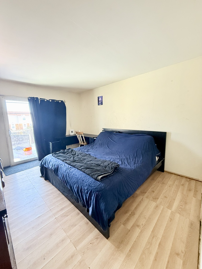 1341 Beverly Lane Streamwood, IL 60107 - Photo 8 of 14 a bedroom with a bed and window