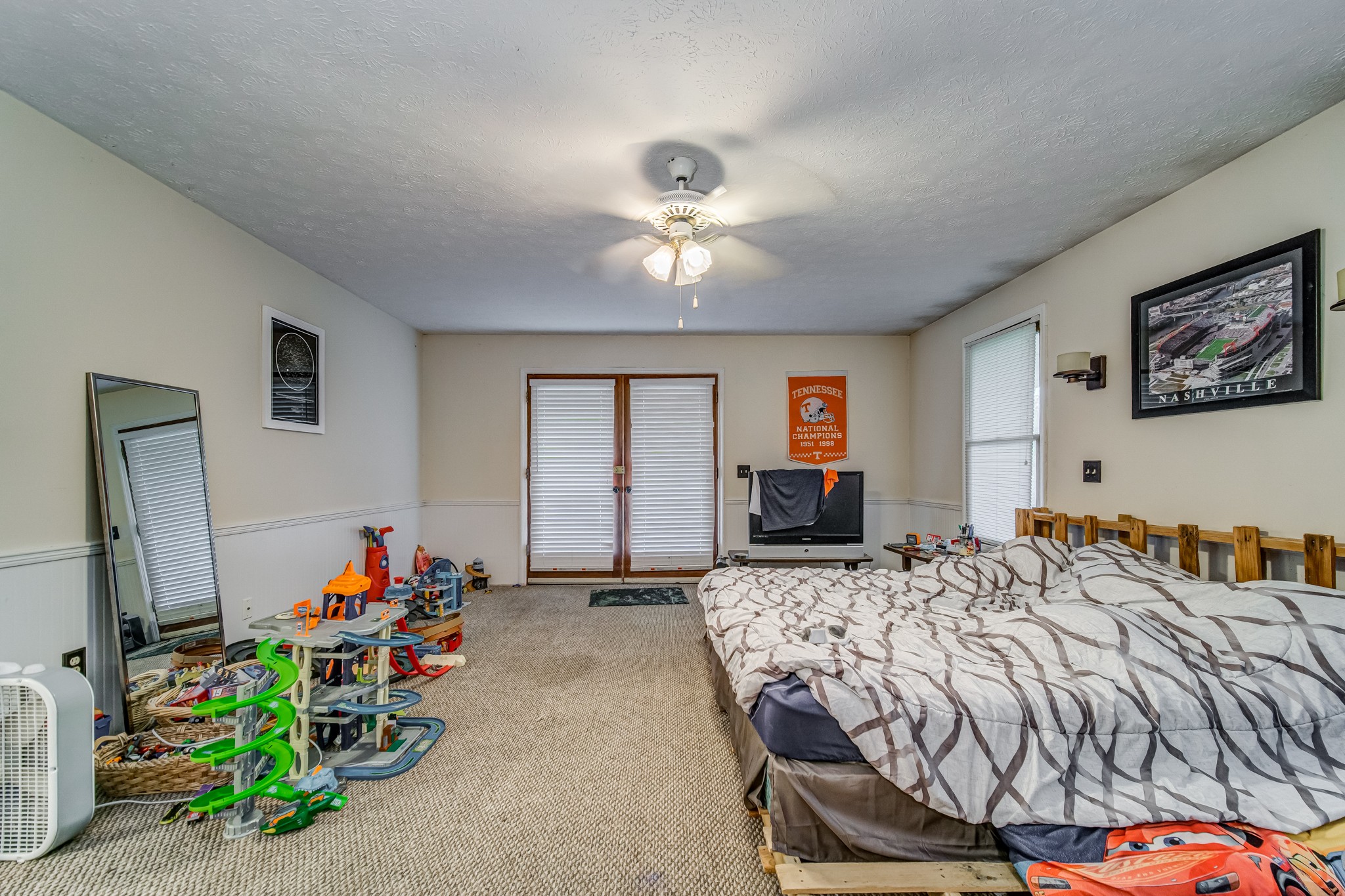 3545 Kelton Jackson Road Springfield, TN 37172 - Photo 24 of 47 a bedroom with a bed and a chandelier
