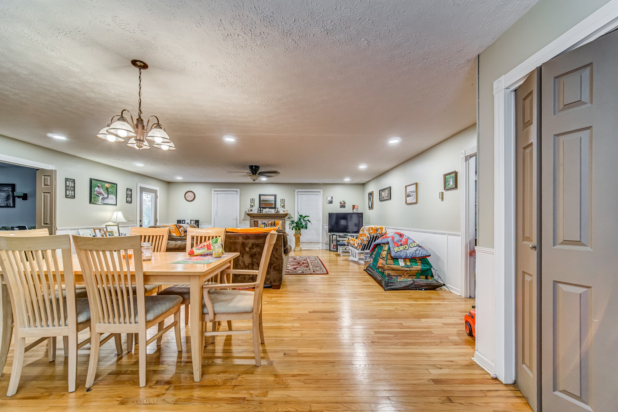 3545 Kelton Jackson Road Springfield, TN 37172 - Photo 6 of 47 a view of a dining room and livingroom with furniture wooden floor a chandelier