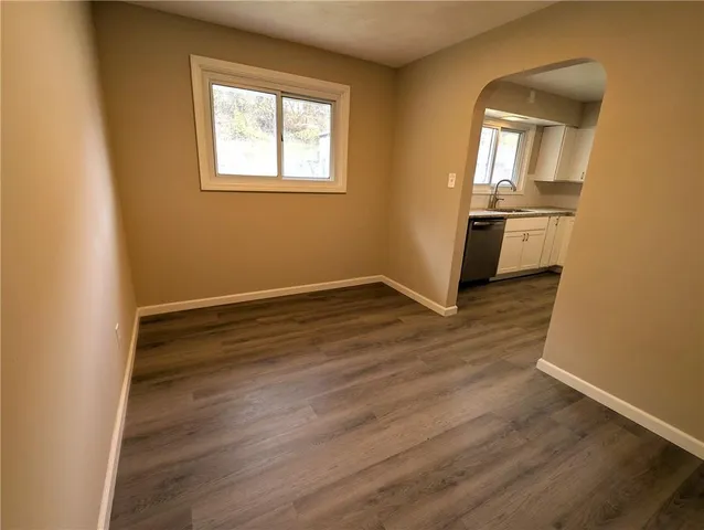 a view of a kitchen with wooden floor and a kitchen