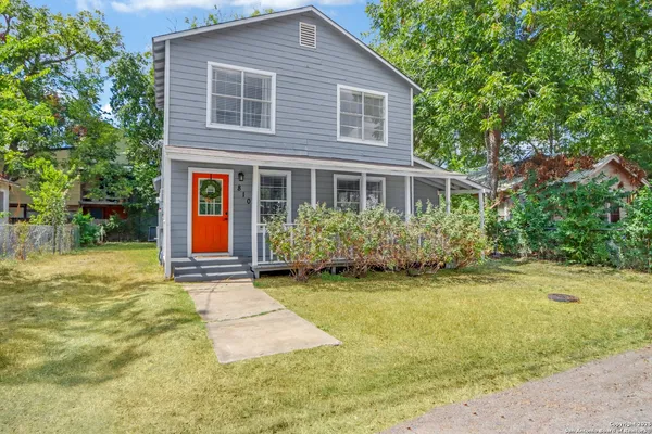 a view of a house with backyard and trees