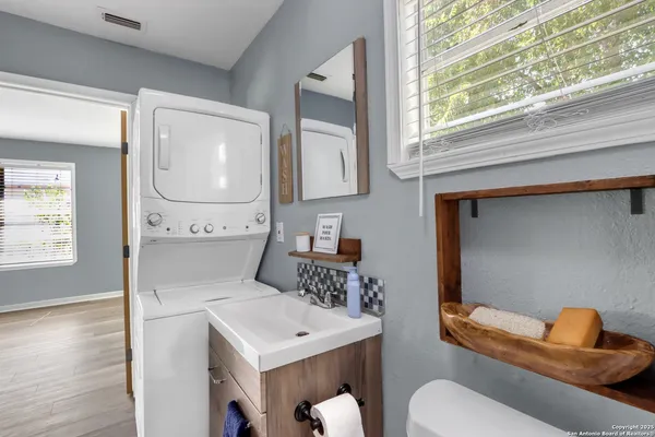 a bathroom with a toilet a sink and mirror