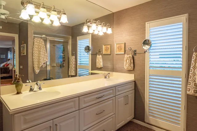 a bedroom with a large bed and a chandelier