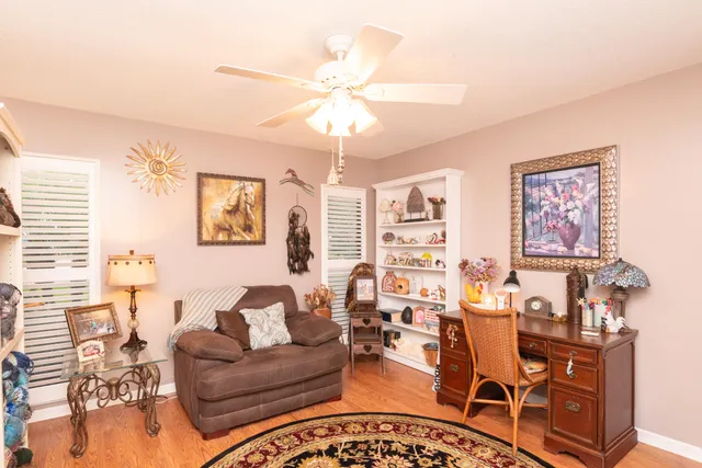 a kitchen with stainless steel appliances granite countertop a refrigerator a stove and white cabinets with wooden floor