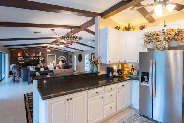 a view of a swimming pool with a porch and furniture