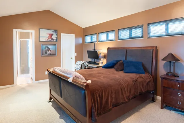 an aerial view of a house with garden space and lake view