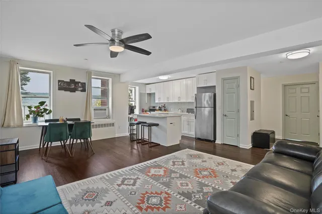 a living room with furniture and kitchen view