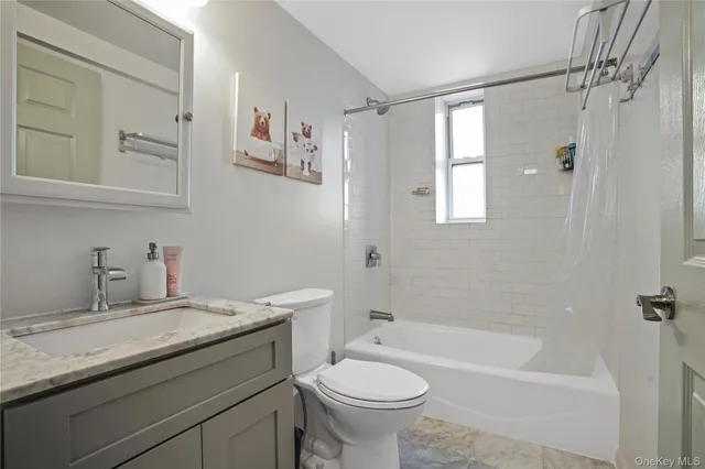 a bathroom with a granite countertop sink a toilet and shower