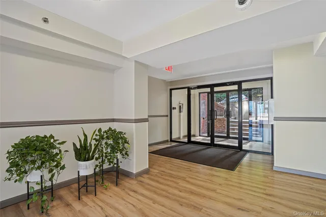 a view of a room with wooden floor and a rug