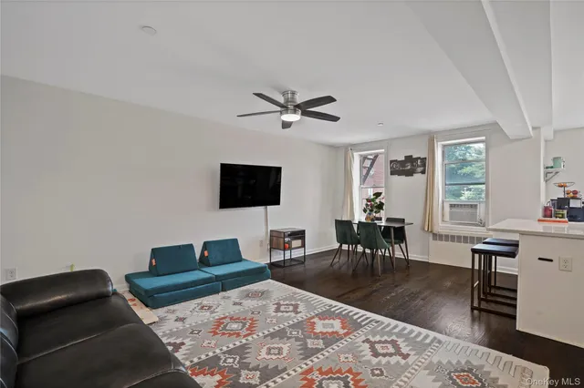 a living room with furniture a rug and a flat screen tv