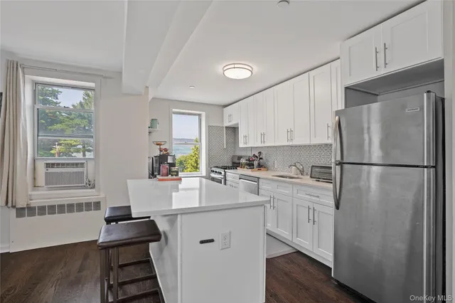 a kitchen with white cabinets and white appliances