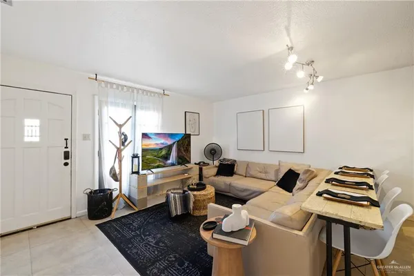 a living room with furniture and a flat screen tv