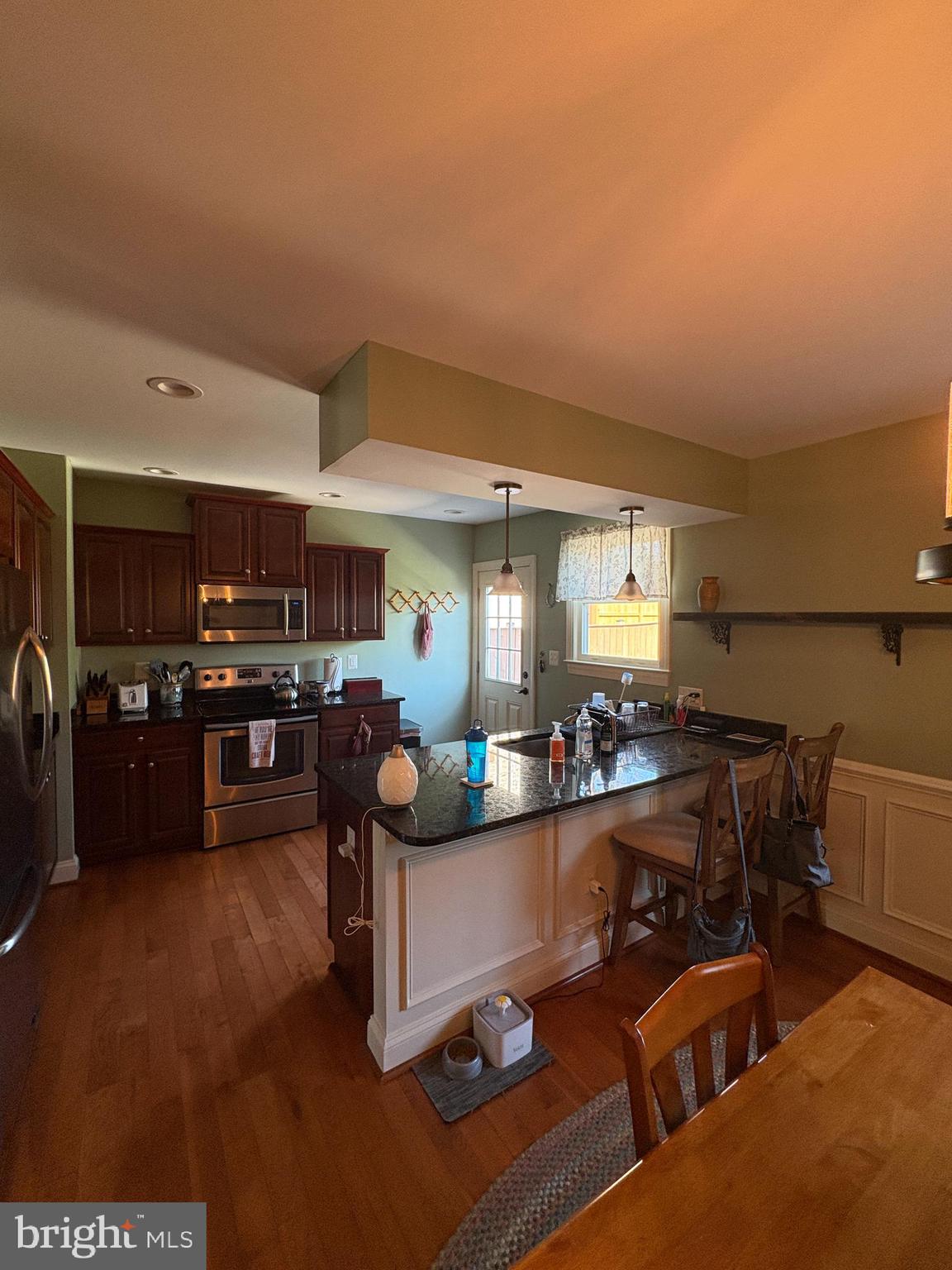 225 East 5th Street Frederick, MD 21701 - Photo 2 of 20 a living room with furniture and a kitchen view
