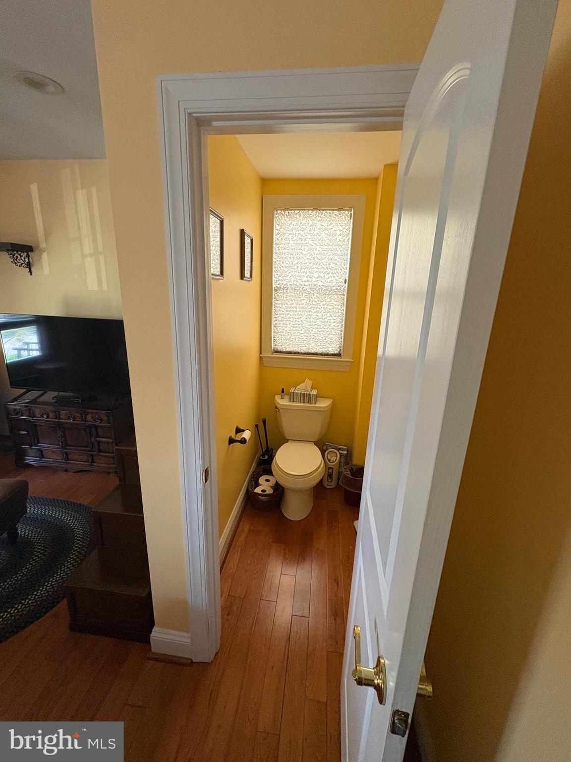 225 East 5th Street Frederick, MD 21701 - Photo 9 of 20 a view of a hallway with wooden floor and a living room