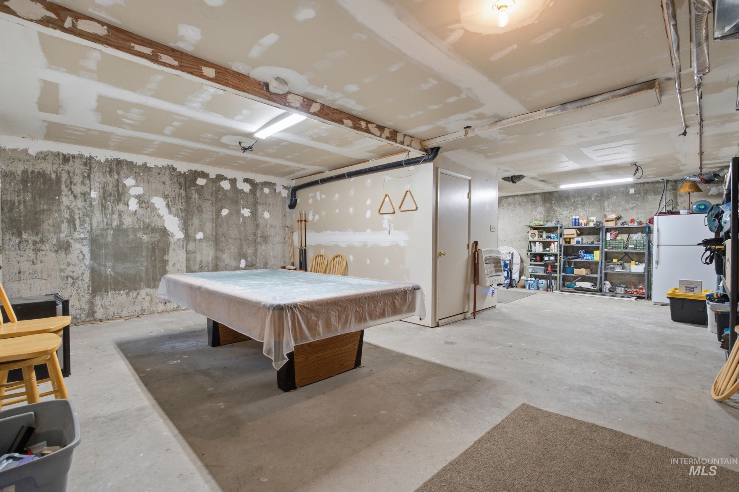 3980 North Pine-Featherville Road Mountain Home, ID 83647 - Photo 22 of 35 Basement space featuring concrete flooring, exposed ceiling beams, and unfinished walls