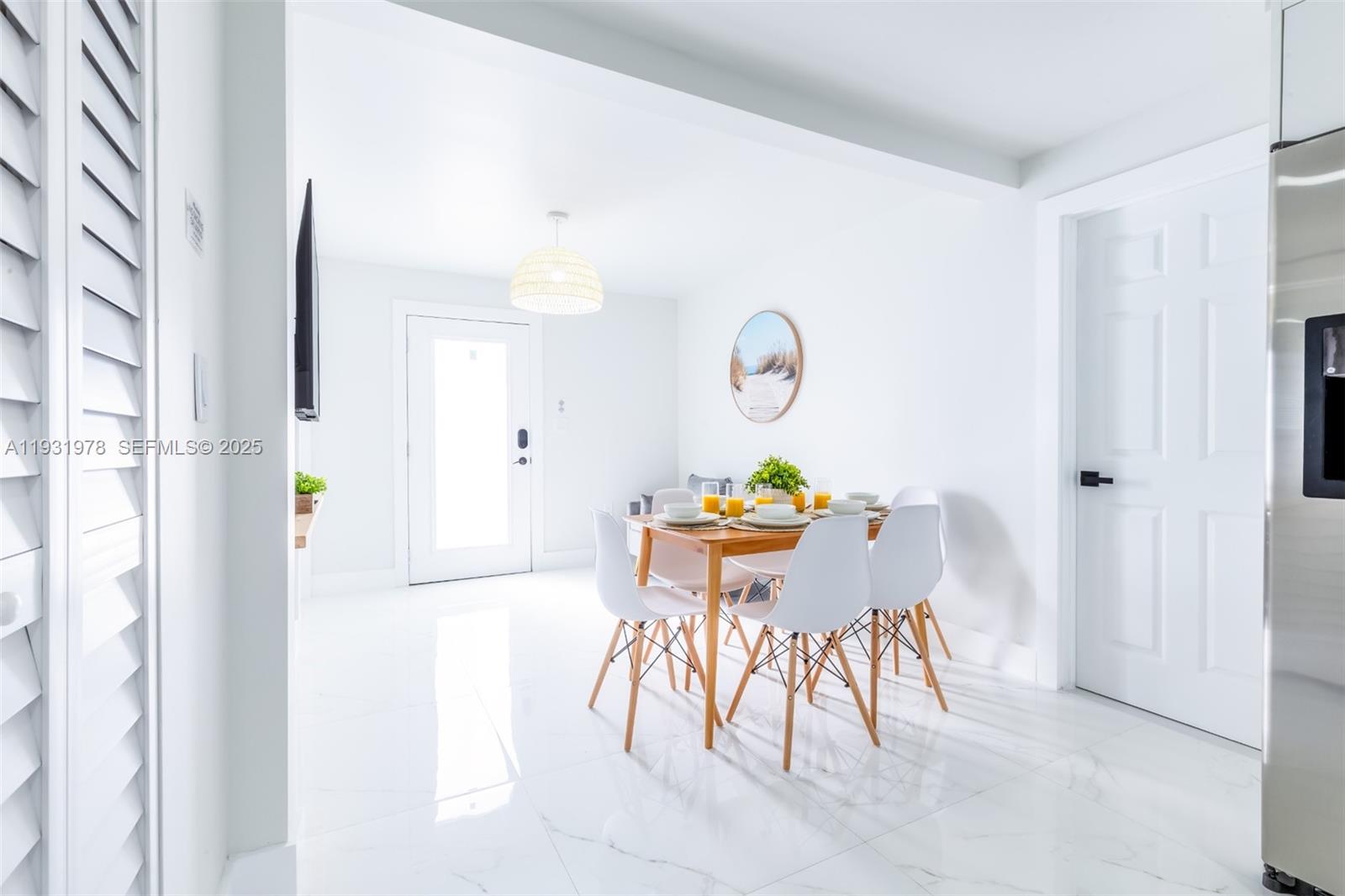 2242 Northwest 64th Street Miami, FL 33147 - Photo 6 of 16 a view of a dining room with furniture and a chandelier