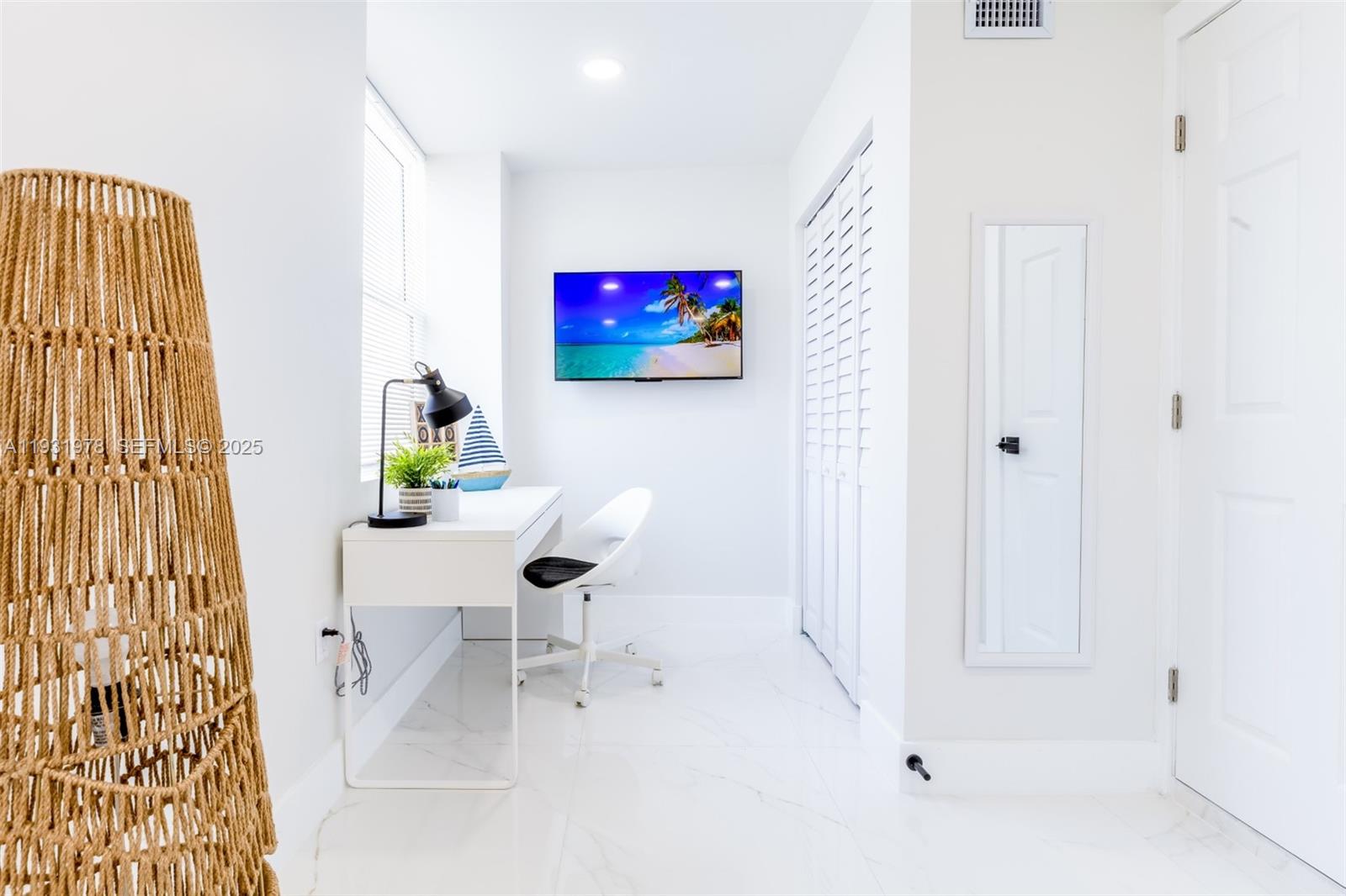 2242 Northwest 64th Street Miami, FL 33147 - Photo 7 of 16 a white couch sitting next to a white wall