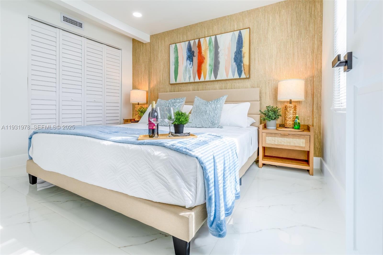 2242 Northwest 64th Street Miami, FL 33147 - Photo 10 of 16 a bedroom with a bed and a painting on the wall