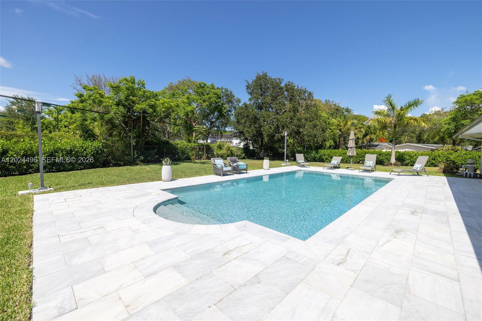 6875 North Cartee Road Palmetto Bay, FL 33158 - Photo 34 of 42 a view of a swimming pool with a yard