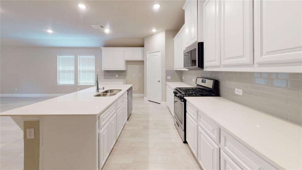 1420 Elizabeth Street Anna, TX 75409 - Photo 4 of 18 a kitchen with a sink stove and cabinets