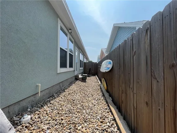 a view of a hallway with wooden floor and stairs