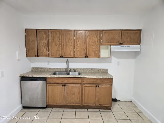 a kitchen with a sink cabinets and utility