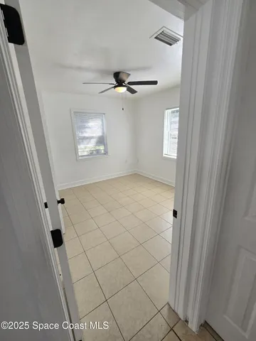 a view of an empty room and a window