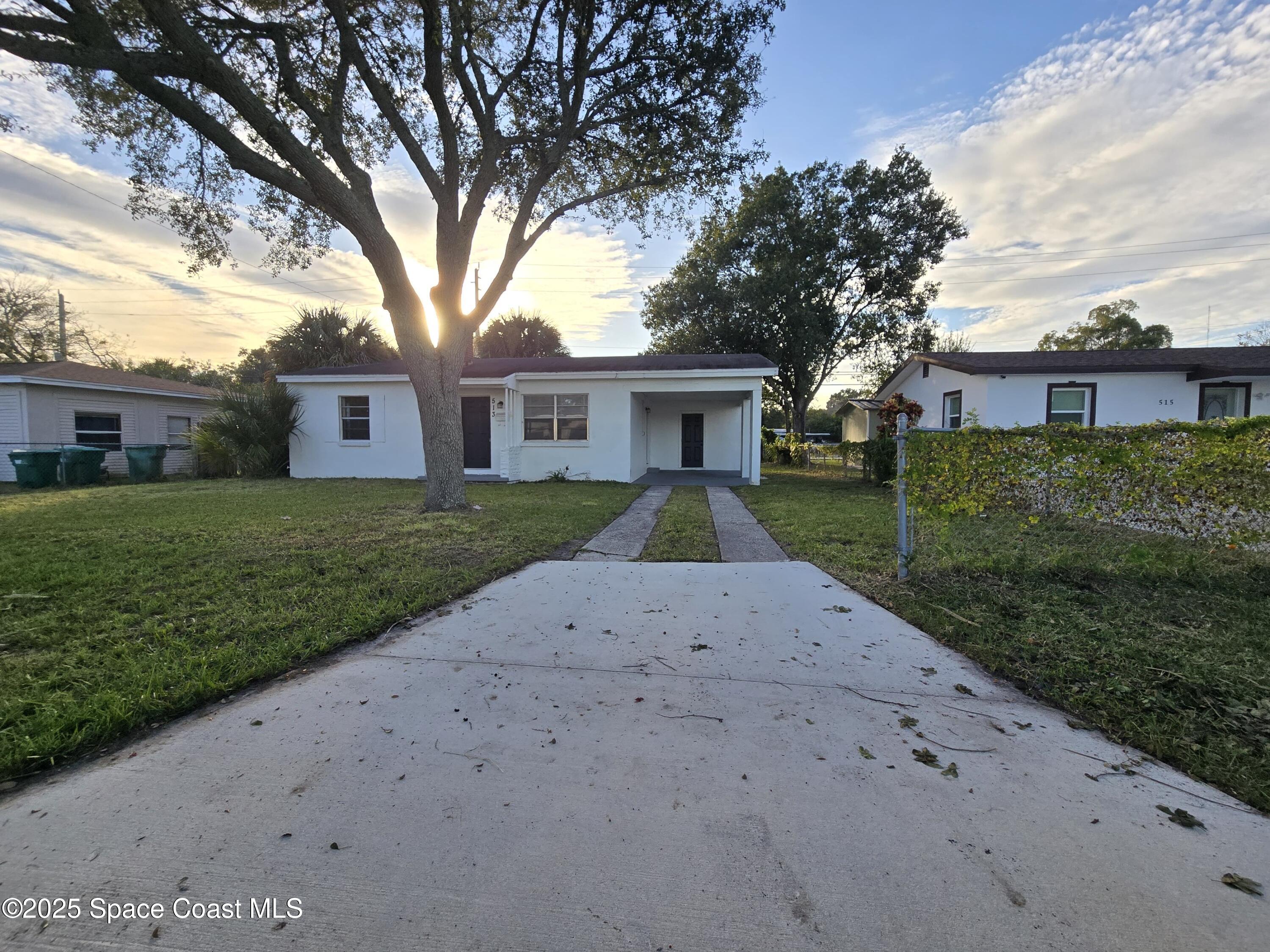 513 North Georgia Avenue Cocoa, FL 32922 - Photo 2 of 20 a front view of a house with a garden and trees