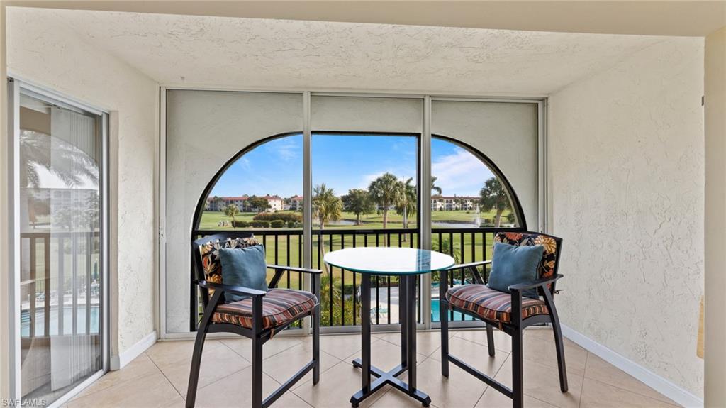 45 High Point Circle South, Unit 304 Naples, FL 34103 - Photo 15 of 20 a view of a balcony with furniture and a window