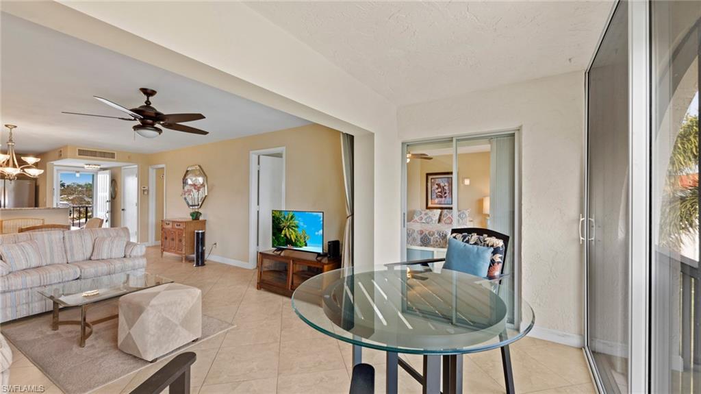45 High Point Circle South, Unit 304 Naples, FL 34103 - Photo 17 of 20 a living room with furniture and a window